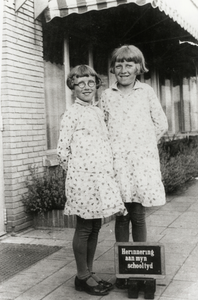 109175 Portret van twee meisjes na afloop van hun schooltijd aan de Amandelschool (Amandelstraat 12) te Utrecht.